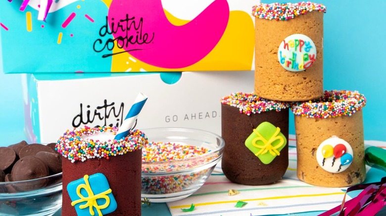 Various Dirty Cookie products with packaging in background