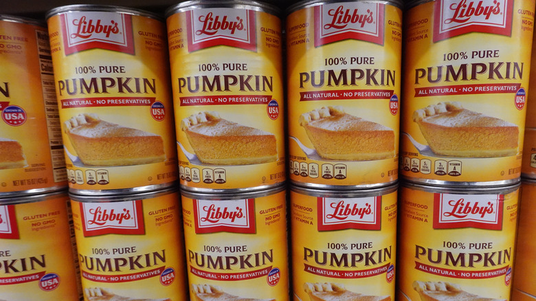 Can of pumpkin puree on a shelf.