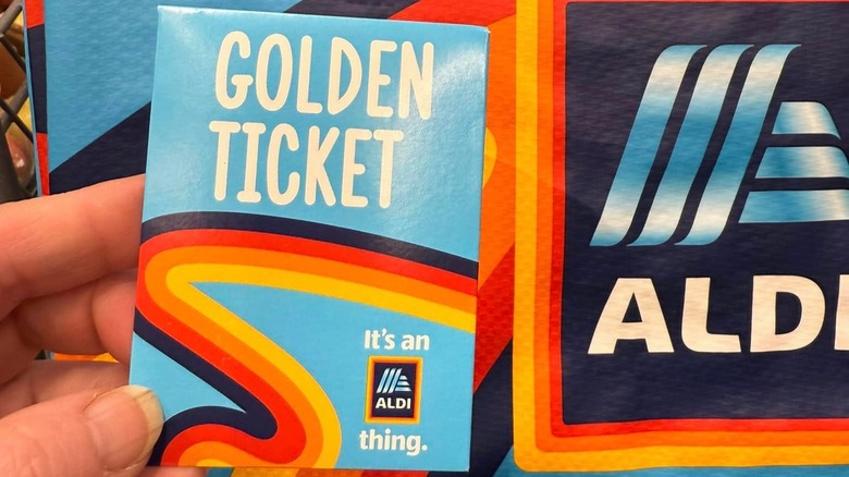 Person holding an Aldi Golden Ticket