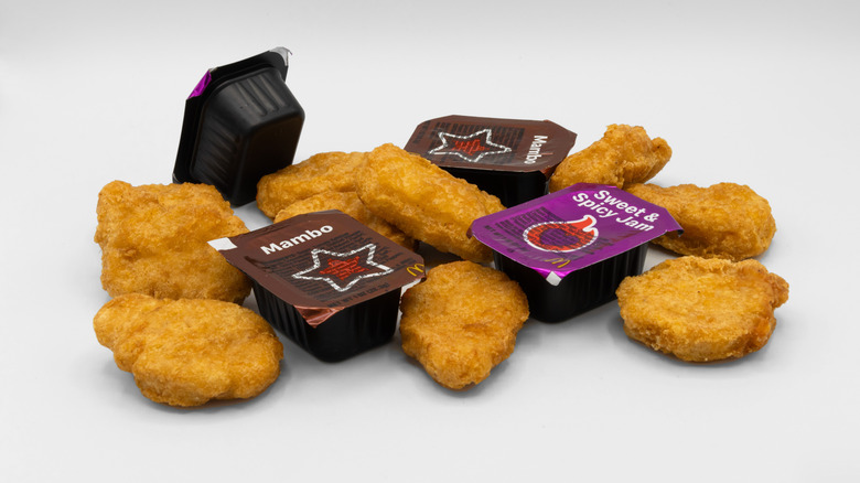McDonald's chicken McNuggets, white background with multiple sauce containers.