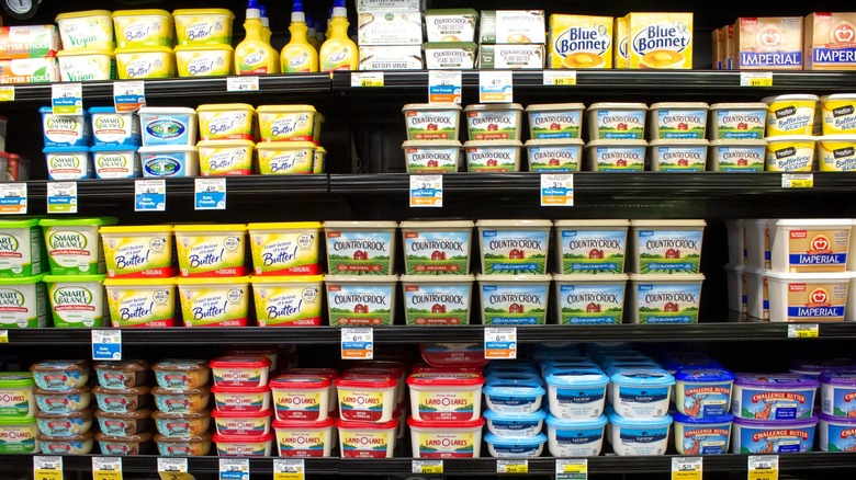 Grocery store shelves with various butter brands
