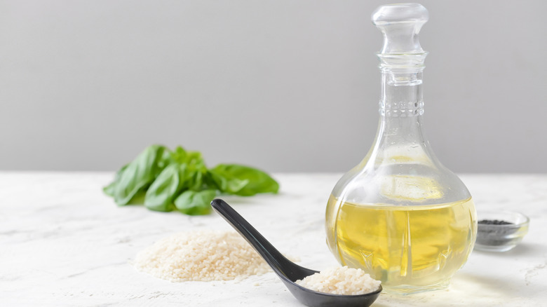Bottle of rice vinegar with spoon full of rice